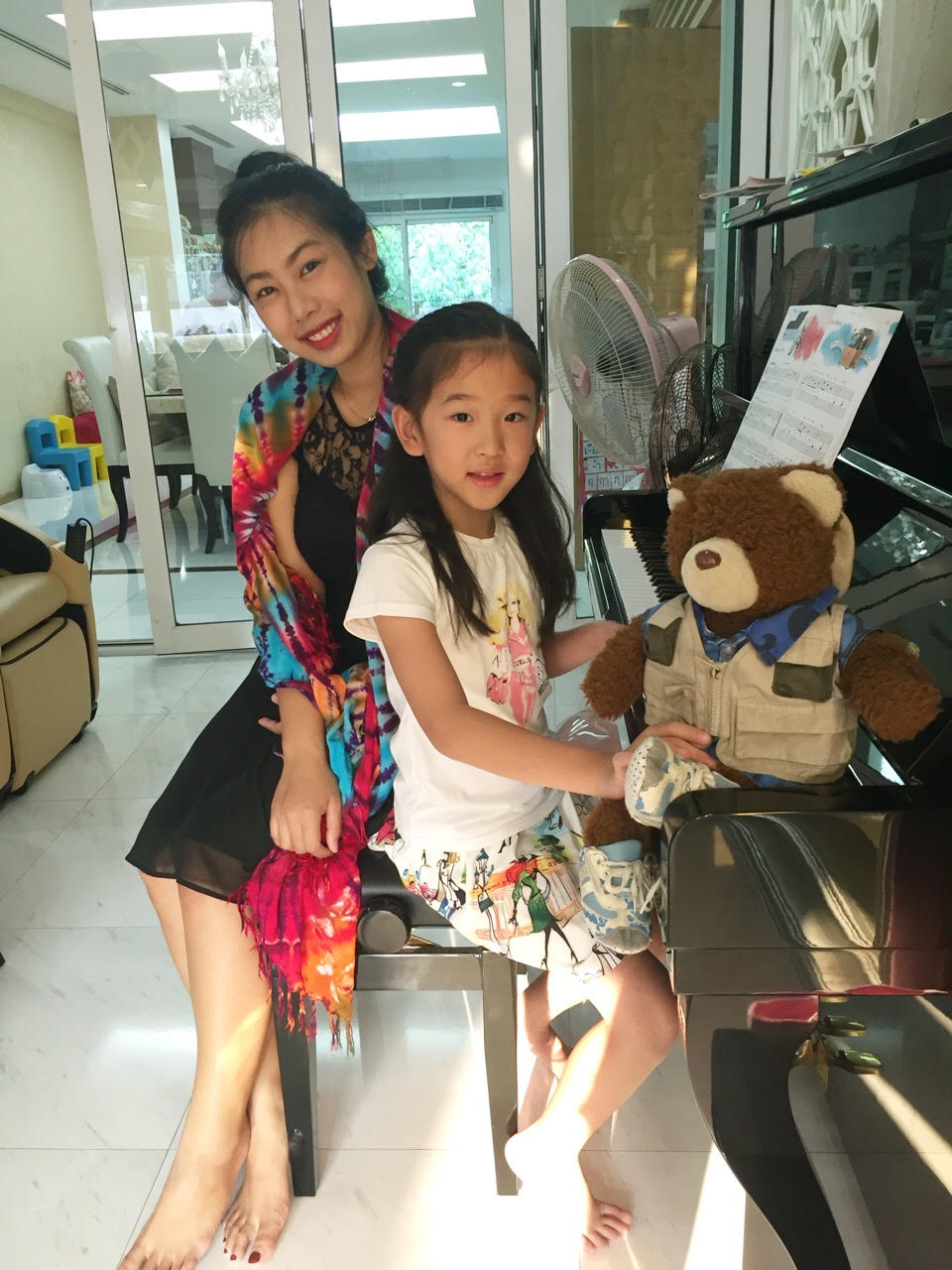 Minnie smiling with a group of young students