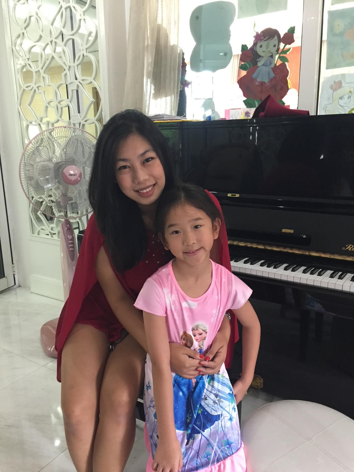 Minnie supporting a young piano student during a recital