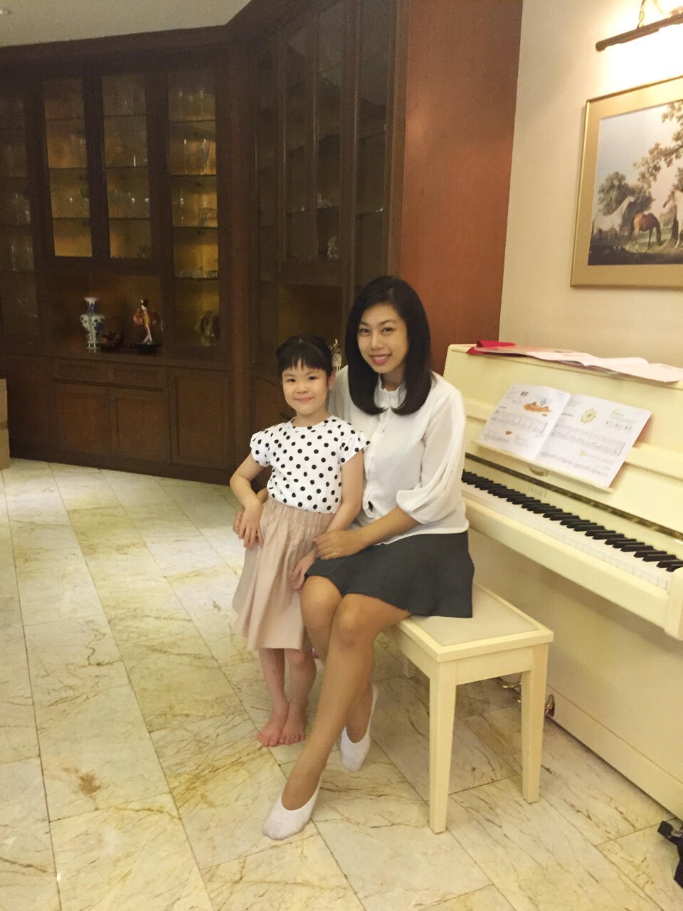 Minnie with a young student at a piano lesson